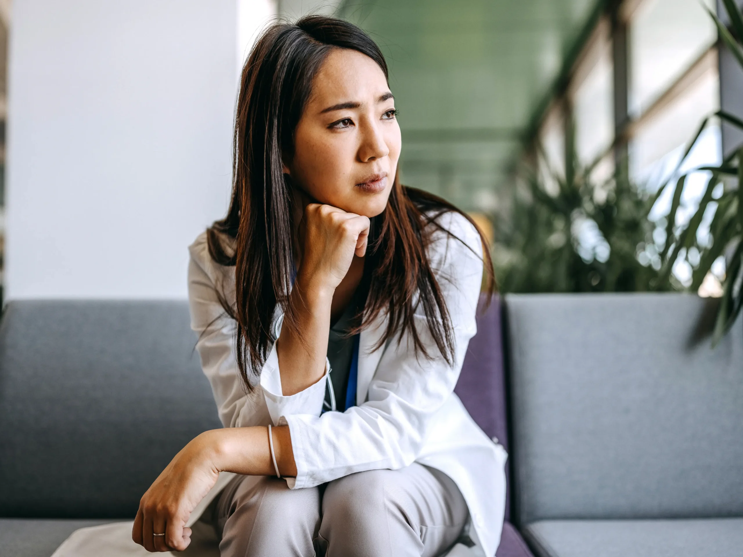 doctor sitting on couch and looking concerned